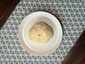Everything bagel flavoured baked bannock on white plate on table.