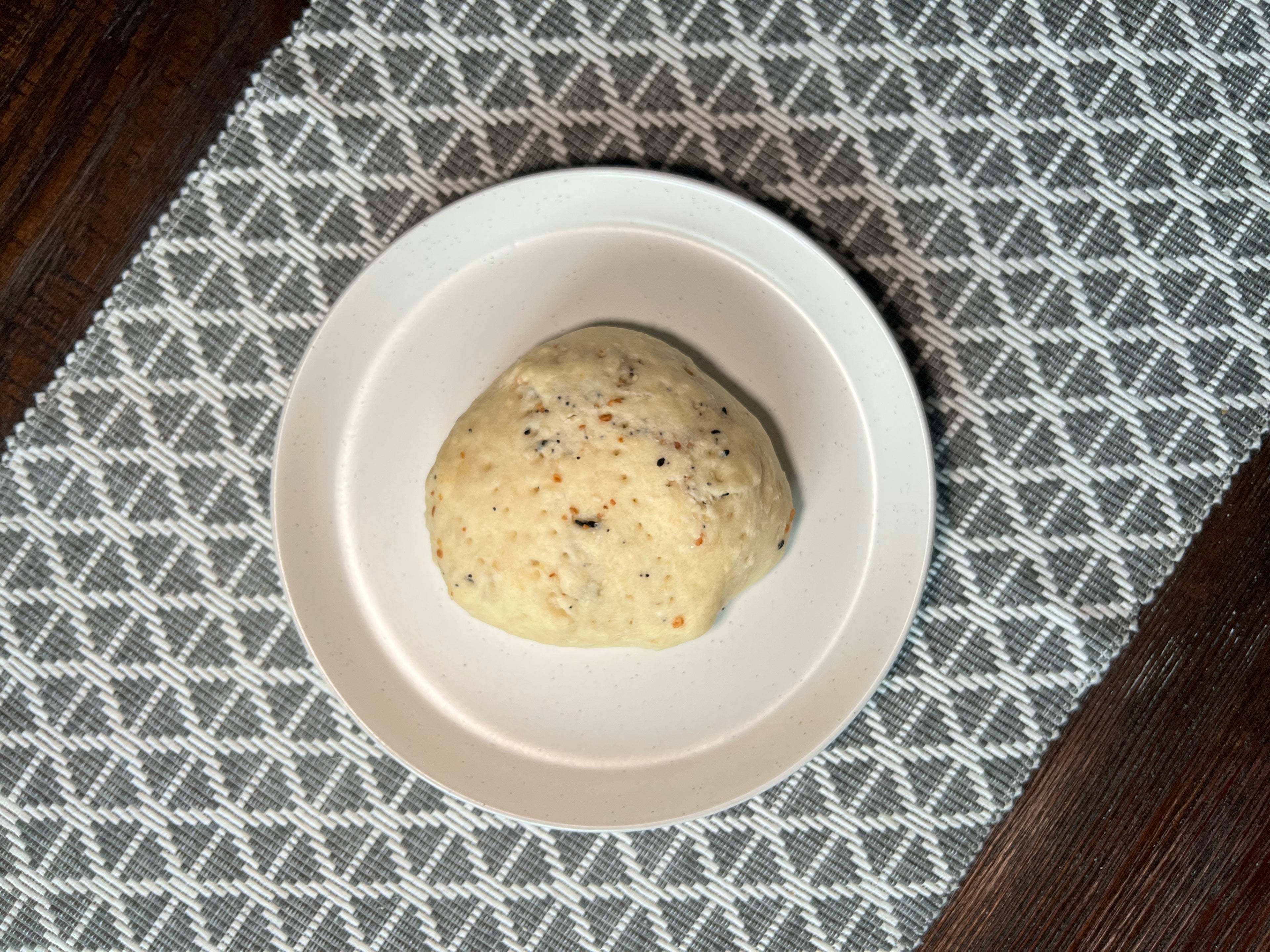 Everything bagel flavoured baked bannock on white plate on table.